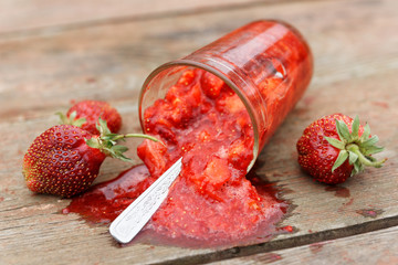 Strawberry smoothie spilled from glass