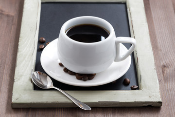 cup of coffee on black chalkboard