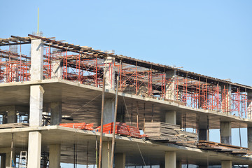 Construction site with scaffolding against blue sky