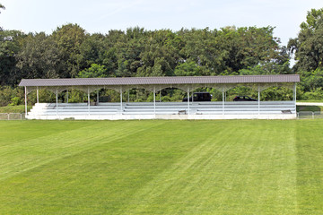 Wooden grandstand with roof and football field