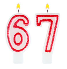 Birthday candles number sixty seven isolated on white background