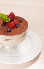 Tiramisu cake in glass with small fruits