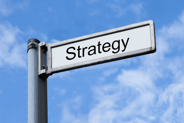 Obraz premium Signpost With Strategy Sign Against Sky