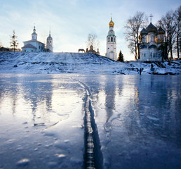 Church on the banks of the frozen river ice winter