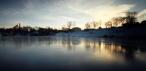 Fototapeta premium frozen river shore small town