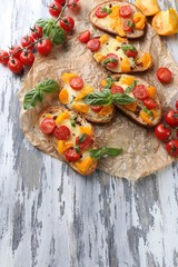 Tasty bruschetta with tomatoes , on old wooden table