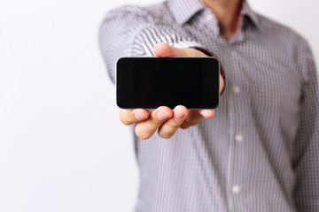 Closeup portrait of a male hand showing smartphone screen