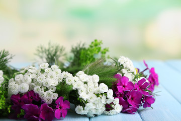Flower wreath on table on nature background