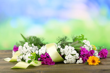 Flower wreath on wooden background