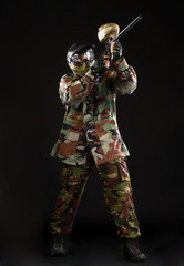 Studio shot of paintball player on black background