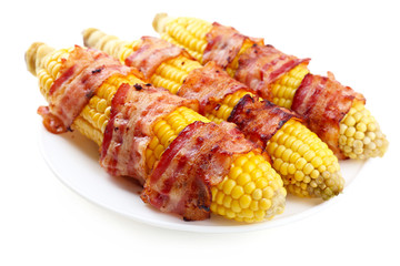 Grilled bacon wrapped corn, isolated on white
