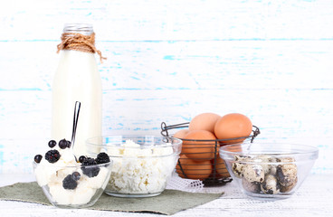 Dairy products and fresh eggs on wooden background