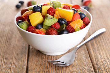 Delicious fruits salad in plate on table close-up