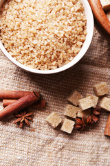 Brown sugar cubes and crystal sugar, spices in bowl