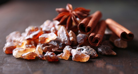 Reed sugar and spices on wooden background