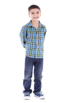 Full length portrait of smiling little boy in jeans on white bac