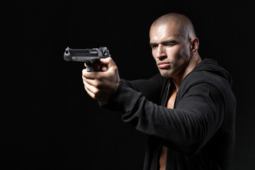 man shooting gun isolated on black background © Tiler84