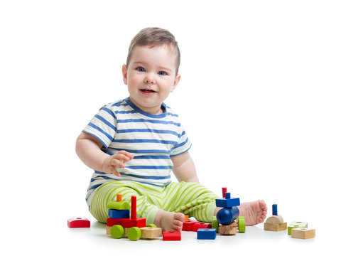 cheerful baby with construction set over white background