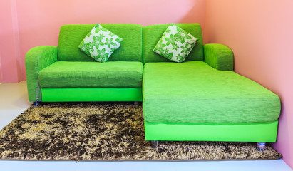 Green sofa in pink room