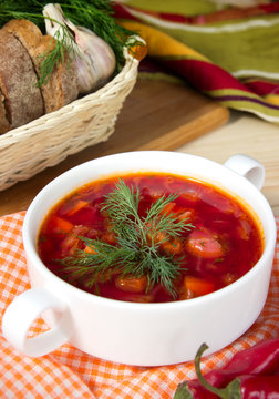 Borsch in white bowl .Red beetroot traditional soup closeup.