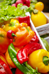 Colorful peppers in a wooden box
