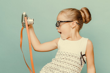  smiling child  holding a  camera