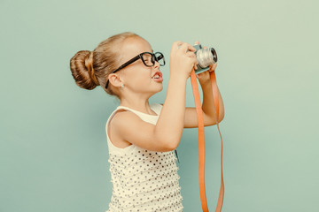  smiling child  holding a  camera