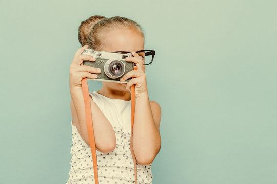  smiling child  holding a  camera