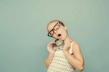  smiling child  holding a  camera