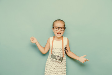  smiling child  holding a  camera