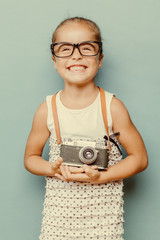  smiling child  holding a  camera