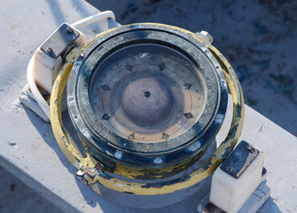 Vintage nautical compass in the cockpit of old yacht, equipment