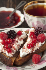 Toast of black bread with curd cream and raspberry, blackberry a