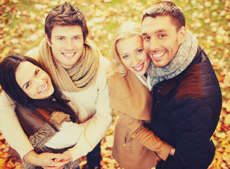 group of friends having fun in autumn park