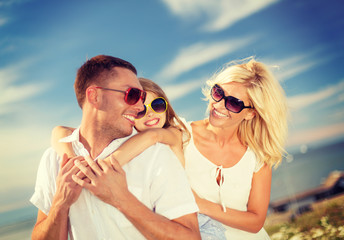 happy family in sunglasses having fun outdoors