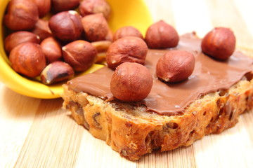 Hazelnut and slices of bread with chocolate cream
