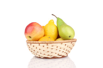 Wicker basket full of juicy fruits.