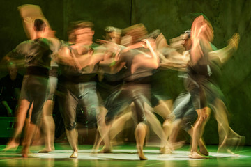 Group of contemporary dancers performing on stage