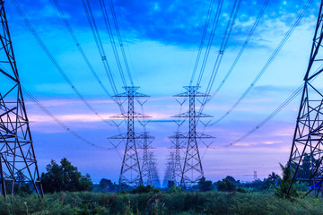 electricity high voltage power pylon at dusk