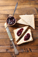 Fresh bread with homemade butter and blackcurrant jam