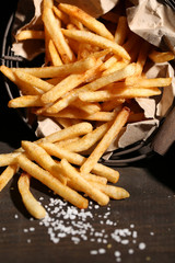 Tasty french fries in metal basket