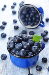 Delicious blueberries in cups on table close-up