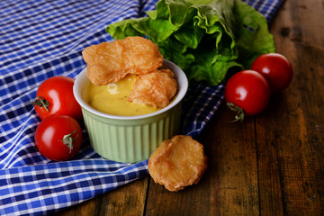 Chicken nuggets with sauce on table close-up