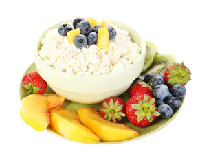 Cottage cheese with fruits and berries in bowl isolated on