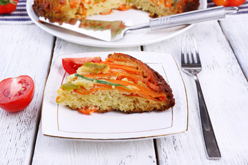 Piece of casserole with vegetables on plate on table close-up