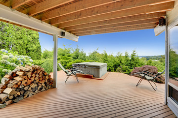 Cozy deck with jacuzzi overlooking scenic nature - obrazy, fototapety, plakaty