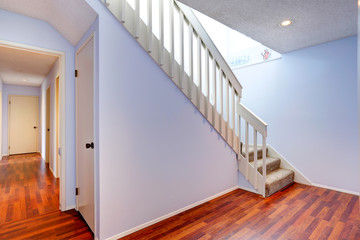 Empty hallway with hardwood floor and stairs