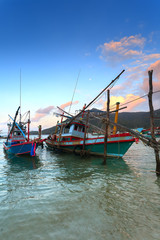 Fototapeta premium wooden fishing boats, water, sunset