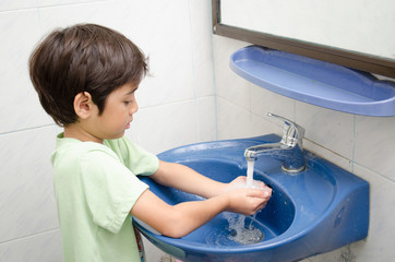 Little boy washing hand