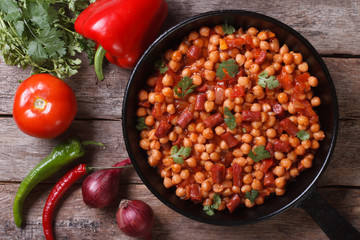 Chickpeas with chorizo ​​in a pan with the ingredients top view